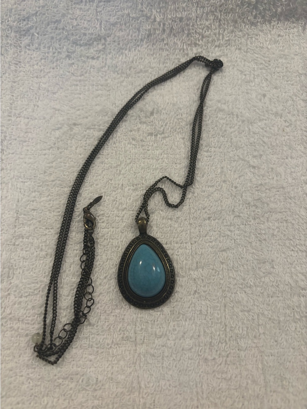 teardrop-shaped faux turquoise cabochon 37”